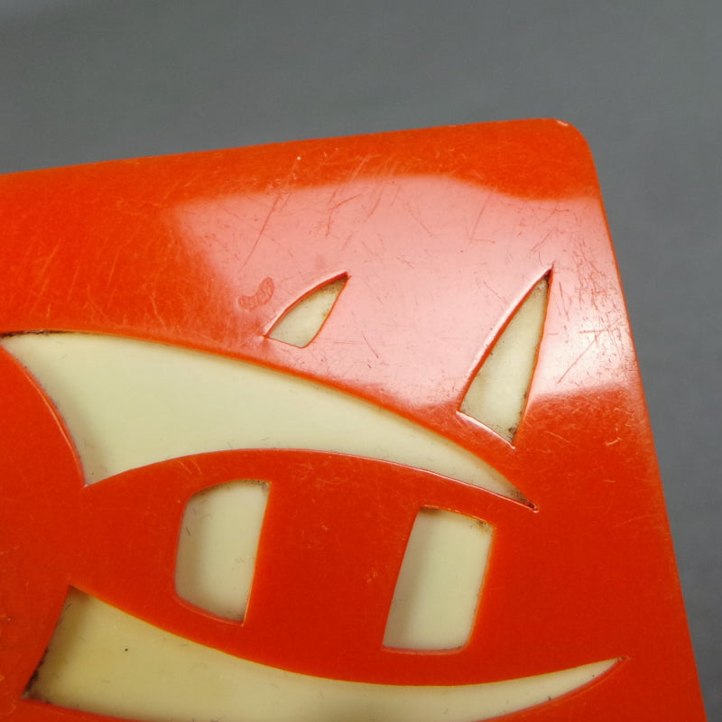 1930s Orange Celluloid Eastern Symbol Brooch
